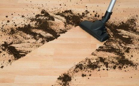 Vacuuming up dirt off of Hardwood Flooring